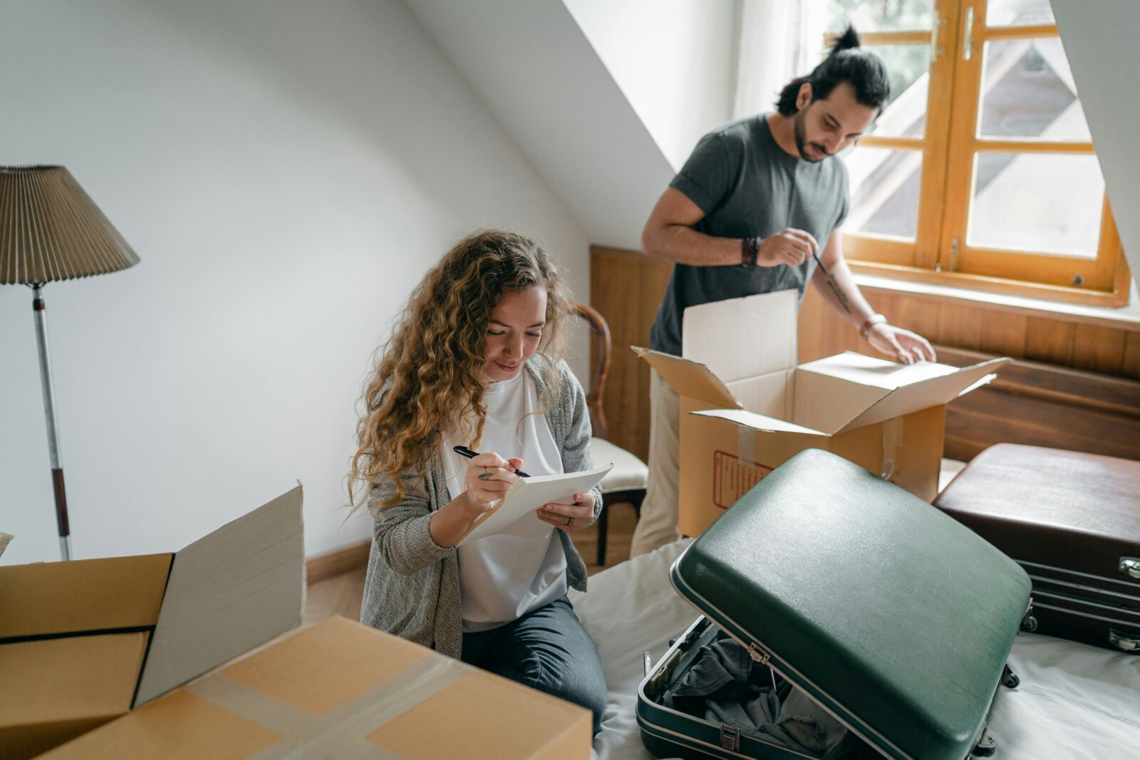 A joyful couple unpacks boxes in their modern, cozy apartment.